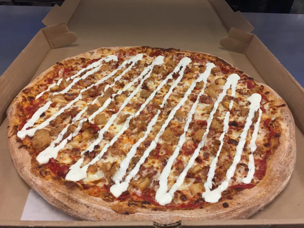 CBR pizza with crispy chicken, bacon and a buttermilk ranch drizzle in an open pizza box