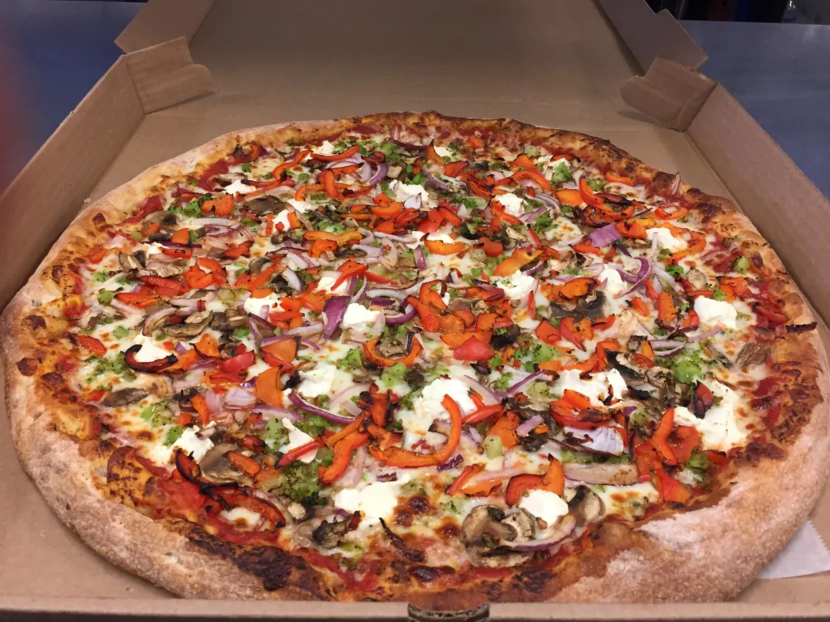 Veggie pizza with mushrooms, broccoli, ricotta, onions and peppers